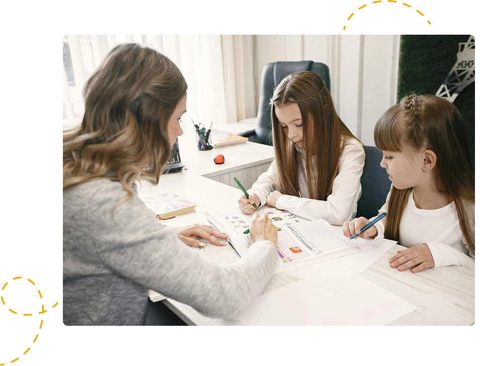 A woman and two girls are sitting at a table