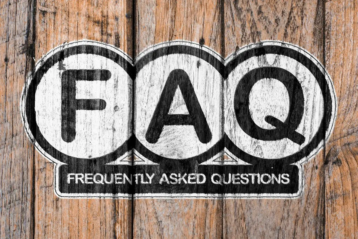 A wooden background with the word faq written on it.